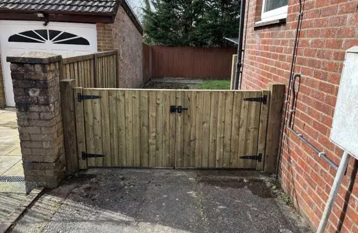 Double timber gates hung between brick pillars